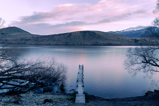 lake near Queenstown at sunrise with a jetty
