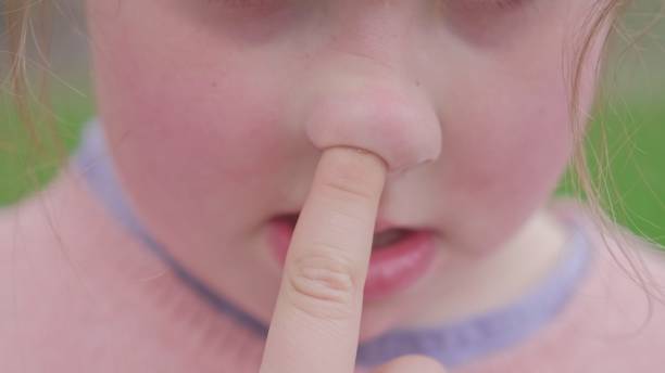istock Young Caucasian Girl Picking Nose with Index Finger Front 1475757190