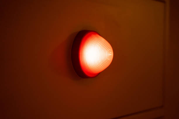 istock A red light bulb glowed on the side wall of the room 1475762256