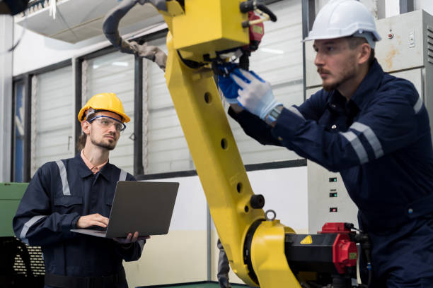 istock Group of male engineer workers maintenance automatic robotic arm at production line in the industry factory. Male technician worker checking, repair automatic robot arm 1475769711