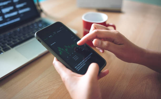 istock Businessman checking stock chart on a smart phone 1475776662