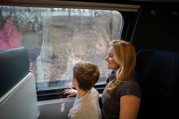 istock Mother travelling on train with son 1475777649