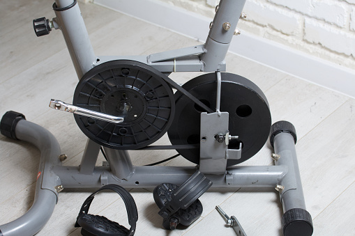 Elements of an exercise bike. Servicing the drive pulley and flywheel. Close-up.