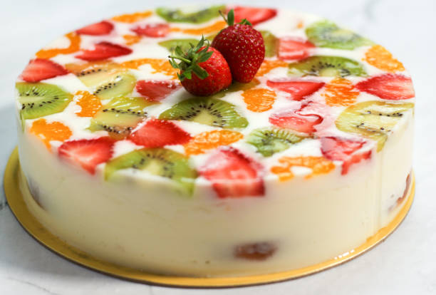 istock delicious homemade fruit pudding. pudding with layers of cake, and topped with strawberries, kiwi and oranges. close up of fruit pudding. 1475778564