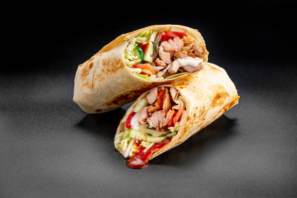 istock Beef shawarma on a dark background. Shawarma with beef in pita bread 1475780233