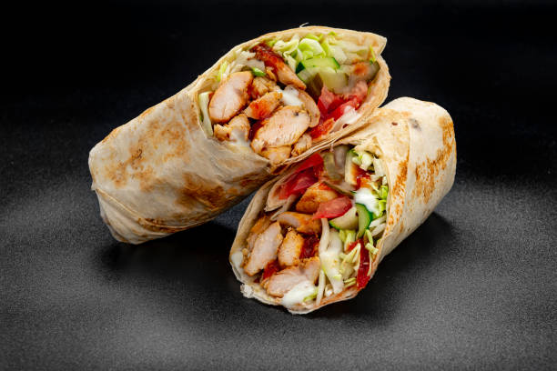 istock Beef shawarma on a dark background. Shawarma with beef in pita bread 1475780245