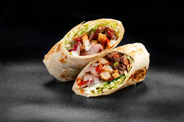 istock Beef shawarma on a dark background. Shawarma with beef in pita bread 1475780254