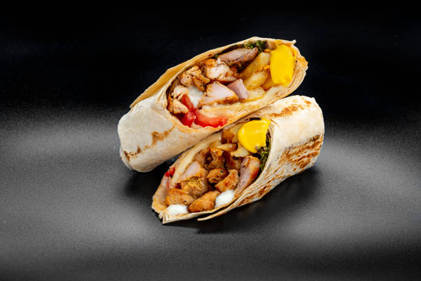 istock Beef shawarma on a dark background. Shawarma with beef in pita bread 1475780255