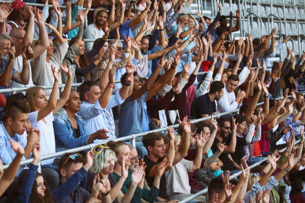 Mexican wave on stadium People doing the mexican wave on the sport or music event. doing the wave stock pictures, royalty-free photos & images
