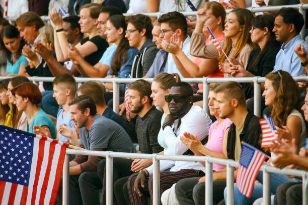 istock Crowd waving USA flags on a stadium 1475780749