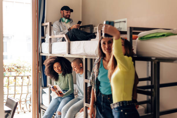 istock young people in college room - backpackers sharing experiences at the hostel - lifestyle generation z 1475781976