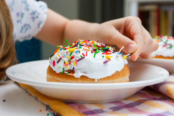 istock Process of decorating a cake with sweet colored decorations 1475783000