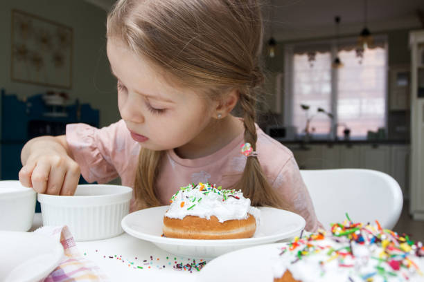 istock Process of decorating a cake with sweet colored decorations 1475783148