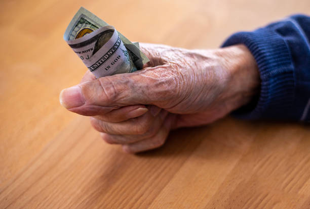 istock An elderly man holds a bill in his clenched fist 1475784407