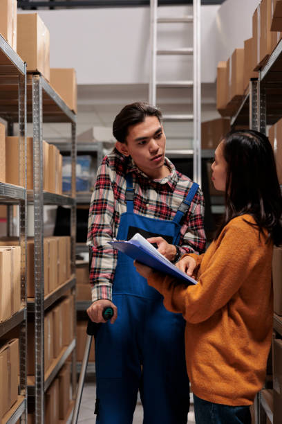 istock Warehouse manager teaching coworker managing order picking and fulfillment 1475785005