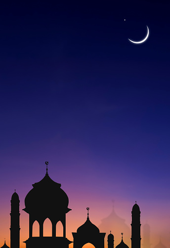 Silhouette Mosques Dome and Crescent Moon on Dark blue Vertical Twilight Sky, suitable background for Iftar period during Ramadan Holy month