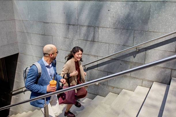 istock Coworkers walking up staircase in downtown district 1475791180