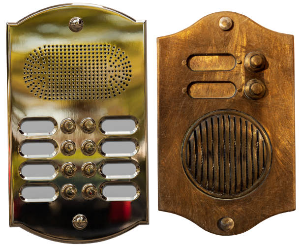 Close-up of a brass intercom and old rusty intercom with doorbells, isolated on white background, photography.