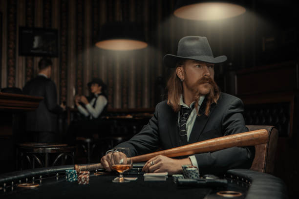 istock Handsome Bearded Gangster Man at the poker table 1475793467