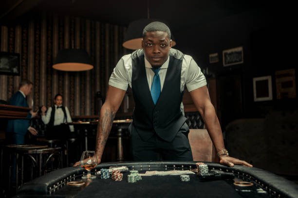 Handsome Black Gangster Man at the poker table stock photo