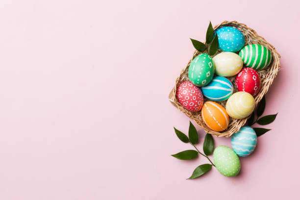 istock Multi colors Easter eggs in the woven basket on colored background . Pastel color Easter eggs. holiday concept with copy space 1475794823