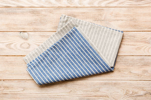 istock top view with blue kitchen napkin isolated on table background. Folded cloth for mockup with copy space, Flat lay. Minimal style 1475794938