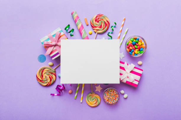 flat lay holiday composition. paper blank, lollipop, birthday decorations on colored background. top view, copy space for text - flavored ice variation birthday candy imagens e fotografias de stock