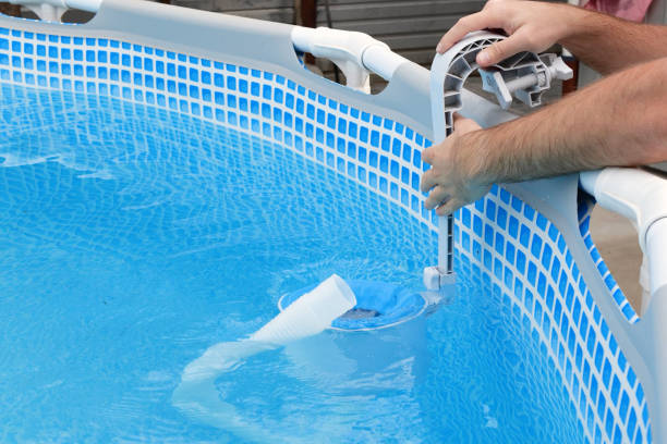 istock Man cleans skimmer for the frame pool. Contaminated pool cleaning concept 1475795006