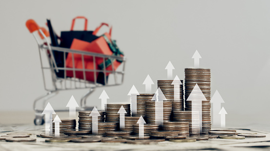 stack of silver coins with shopping basket backgorund.financial concepts and financial investment business stock growth.Inflation, hyperinflation in the dollar.