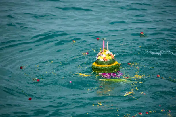 banana leave vessel with scatter ashes floating over the sea. Thai traditional funeral.