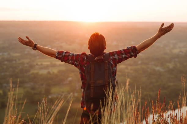 istock Unrecognizable traveler praying at sunrise 1475800570