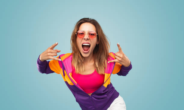 istock Young woman gesturing rock sign 1475800712