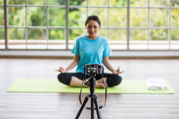istock Behind the scene of vlog yoga training. Focus on camera screen 1475800826