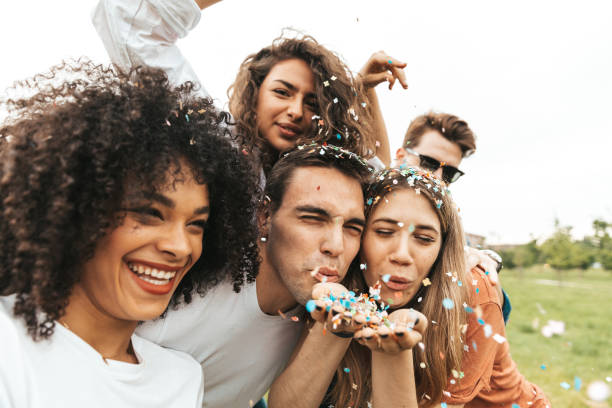 istock Group of mixed ethnicities friends having fun in a park 1475803767