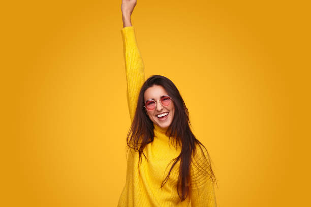 istock Excited ethnic lady with raised arm smiling while celebrating success 1475804291