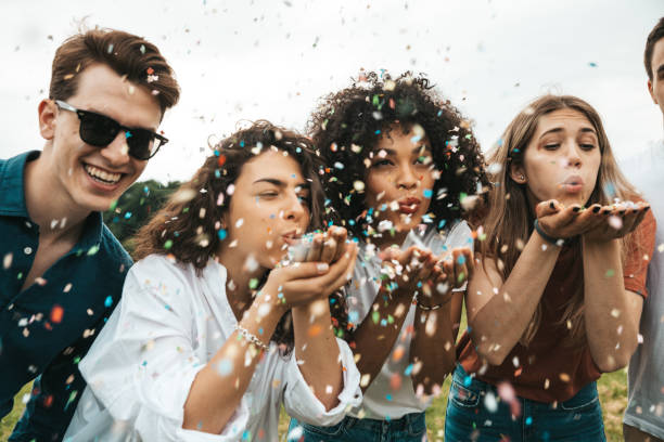 istock Group of mixed ethnicities friends having fun in a park 1475804566