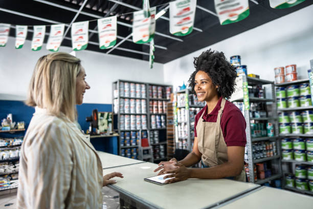 istock Saleswoman attending a customer at a paint store 1475805267