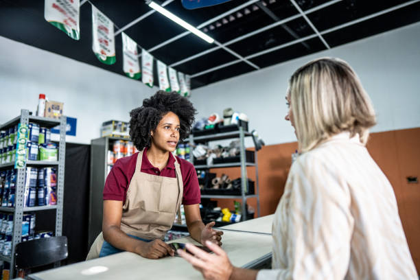 istock Saleswoman attending a customer at a paint store 1475805280