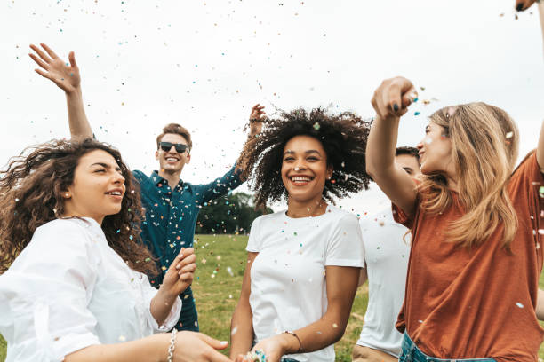 istock Group of mixed ethnicities friends having fun in a park 1475805365