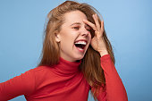 Cheerful redhead woman laughing at joke