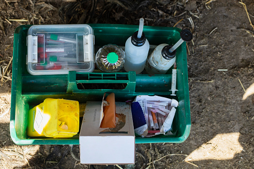 A tray of medicinal equipment on the ground at a farm in Embleton, North East England. It is ready to be used to give medicine to the animals on the farm.