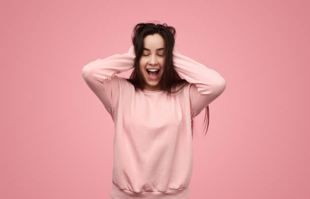 istock Delighted young lady yelling happily with closed eyes in studio 1475805866
