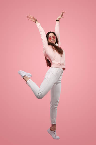 istock Positive young lady dancing against pink background in studio 1475805888