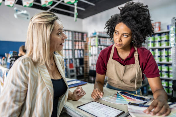 istock Saleswoman attending a customer at a paint store 1475806202