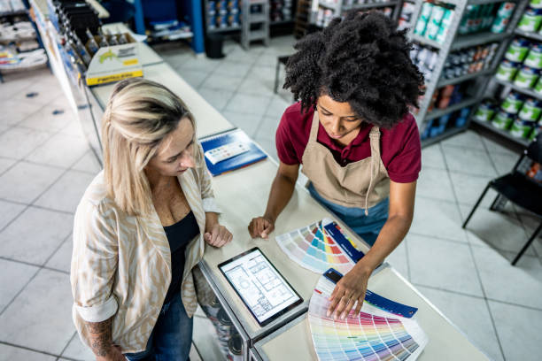 istock Saleswoman attending a customer at a paint store 1475806210