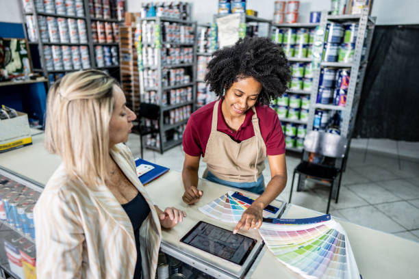 istock Saleswoman attending a customer at a paint store 1475806217