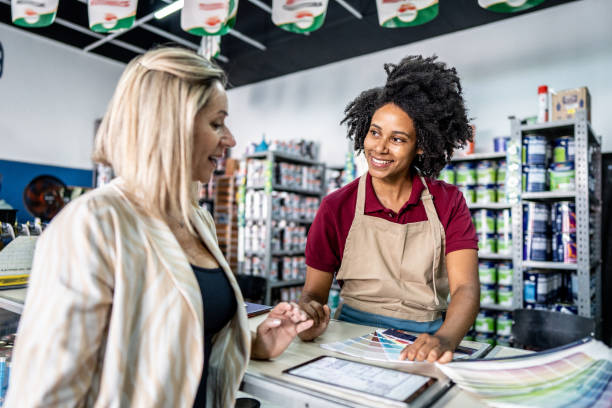 istock Saleswoman attending a customer at a paint store 1475806233