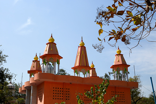 Ancient Hindu temple exterior from amidst trees located in a small city of Haryana state India.