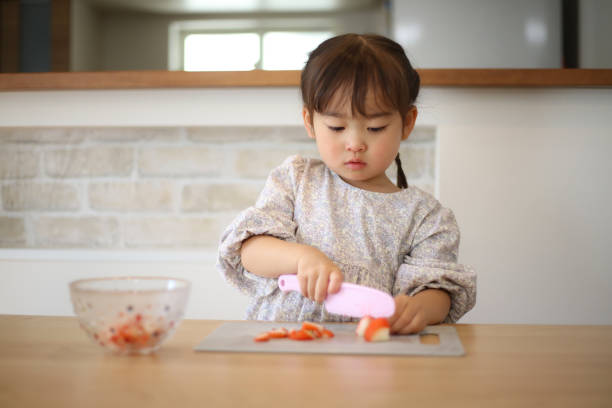 istock girl cutting strawberries 1475810468