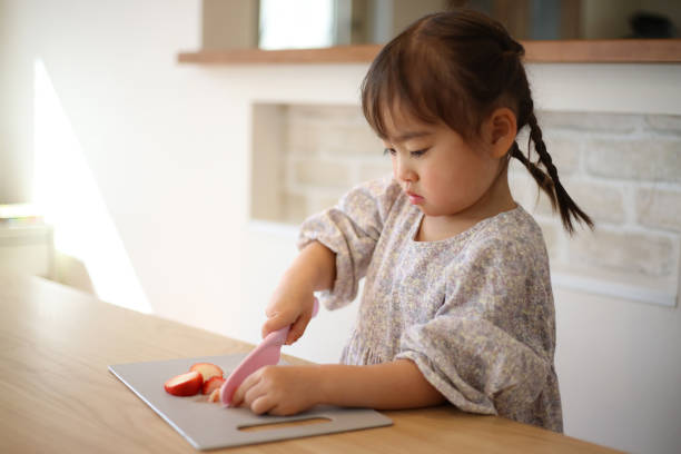 istock girl cutting strawberries 1475810502